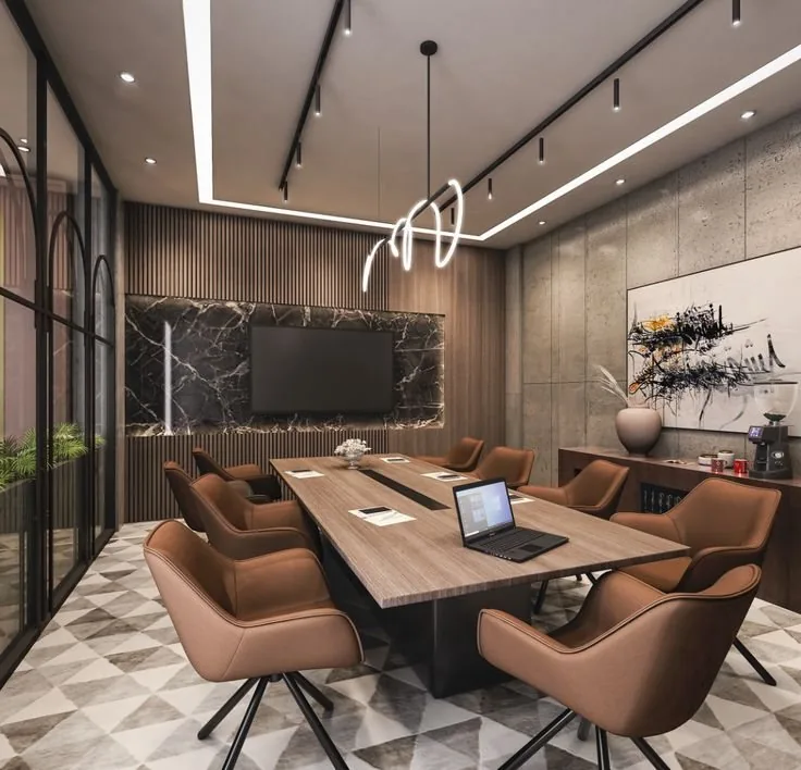 A private meeting room with a long table, leather chairs and a presentation screen