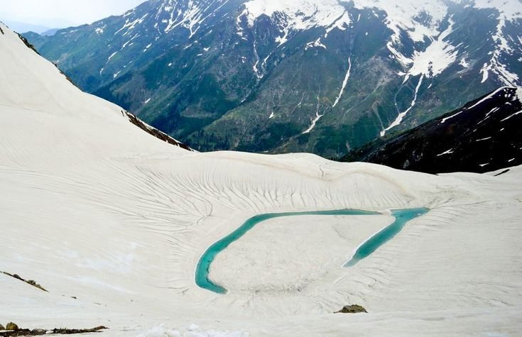 The teardrop of Ansoo Lake set in high snowfields